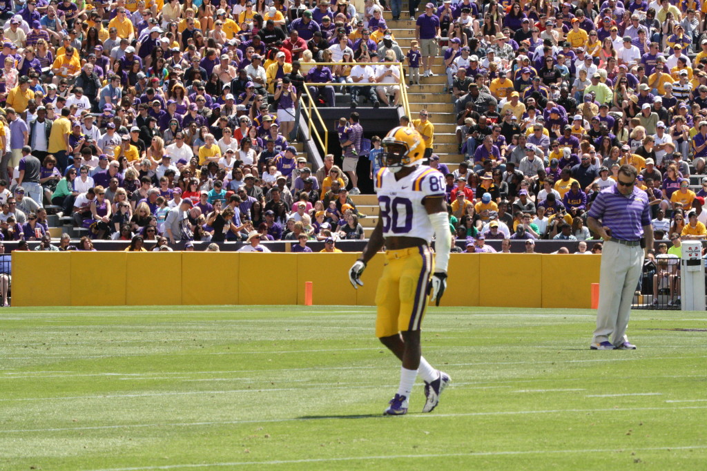 Jarvis Landry gets up after a big hit, and walks back to the huddle.