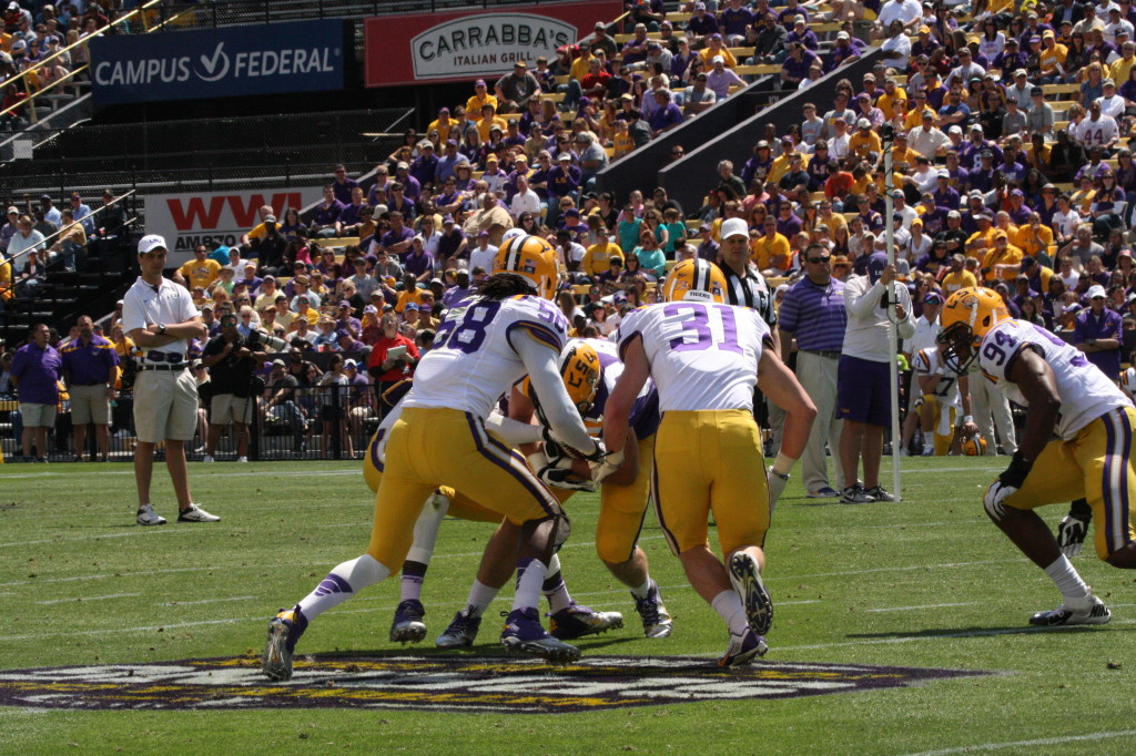 Stokes gets surrounded by Craig Loston, D.J. Welter, and Tahj Jones.
