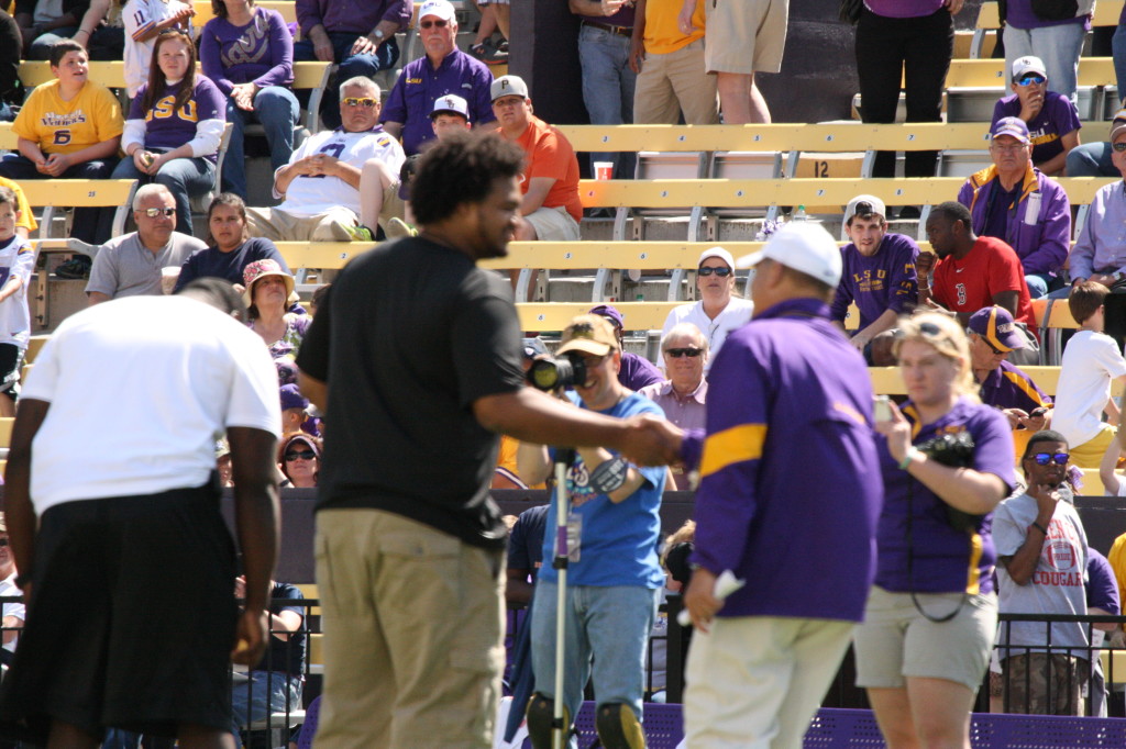 Les Miles giving handshakes to the LSU/NFL players.