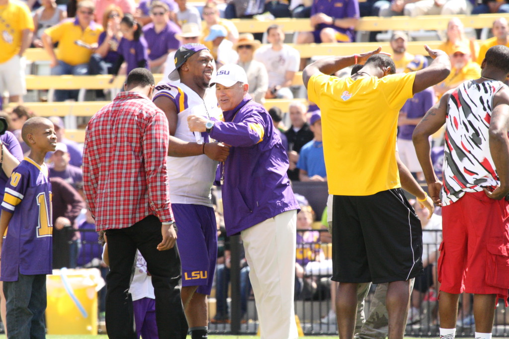 Les Miles gives a hug to Sam Montgomery.