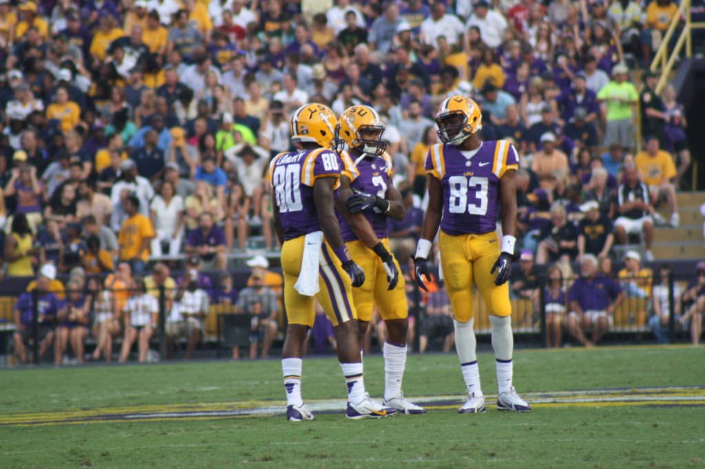 Landry, Odell, and Dural having a discussion at mid-field.