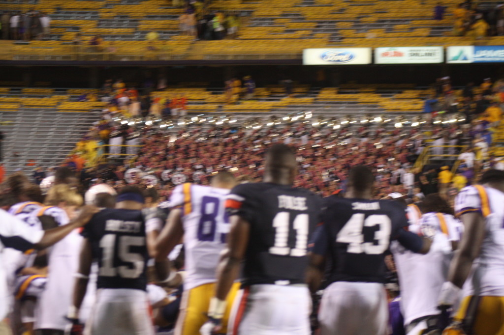 LSU and Auburn players praying after the game.