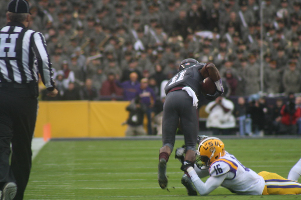 A AM receiver catches the ball as a LSU defender makes a shoe string tackle.