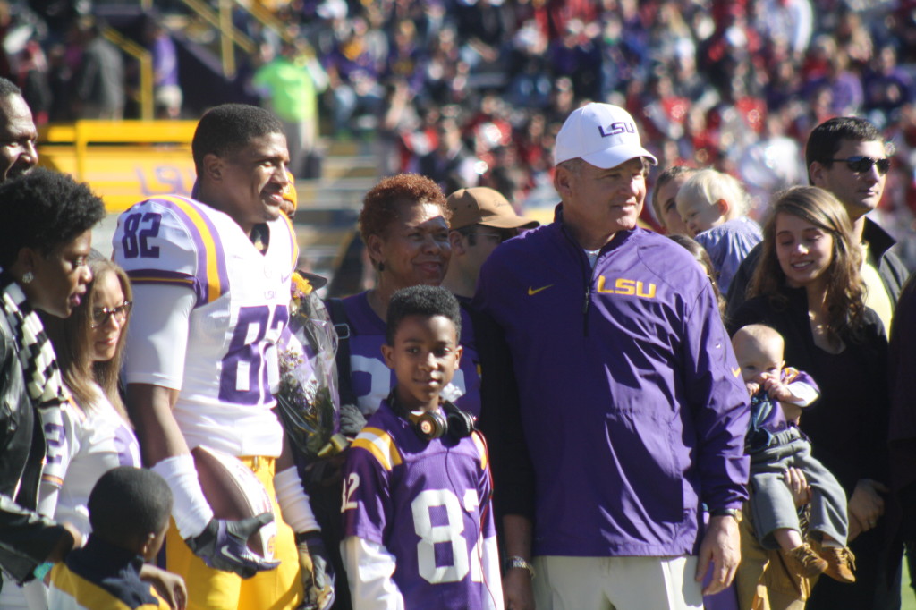 LSU Coach Les Miles takes a pic  with WR 82, James Wright and his family.