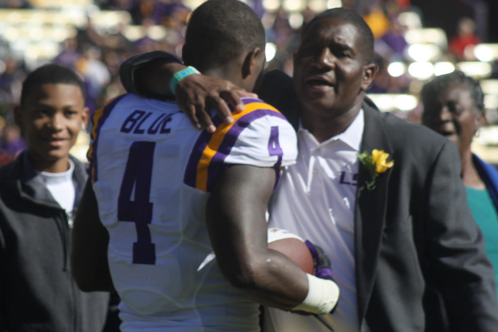 LSU RB Alfred Blue gets hug from his dad.