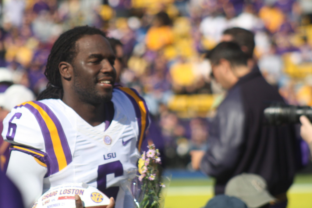 LSU no.6 Craig Loston runs on the field for senior day.