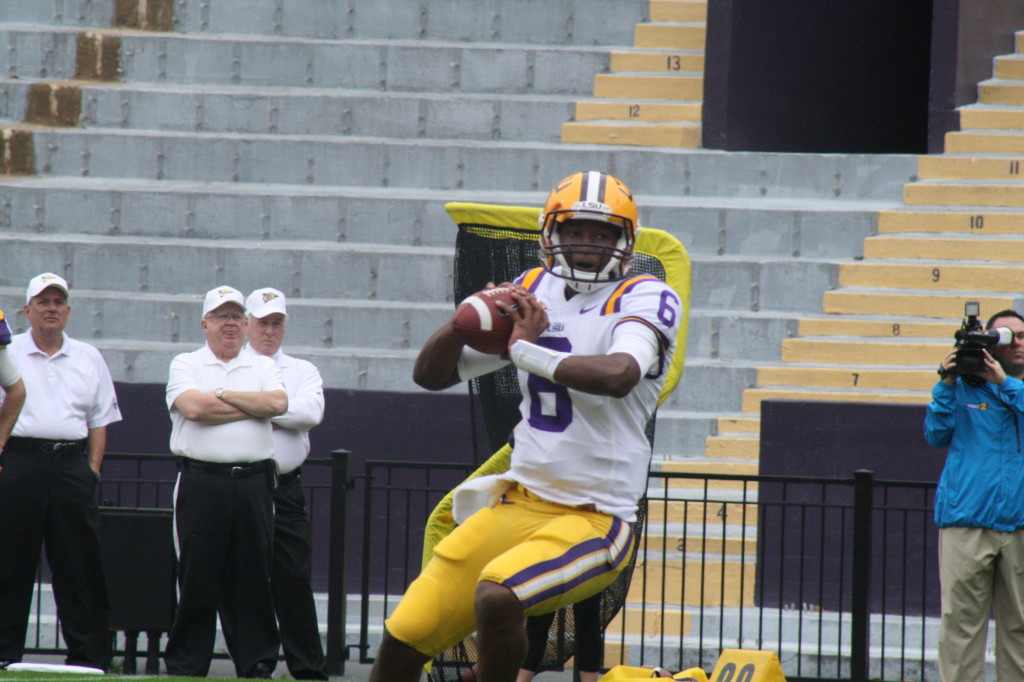 no.6 Brandon Harris rolls out and gets ready to throw a pass.