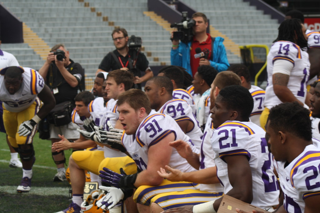 LSU players taking a knee.