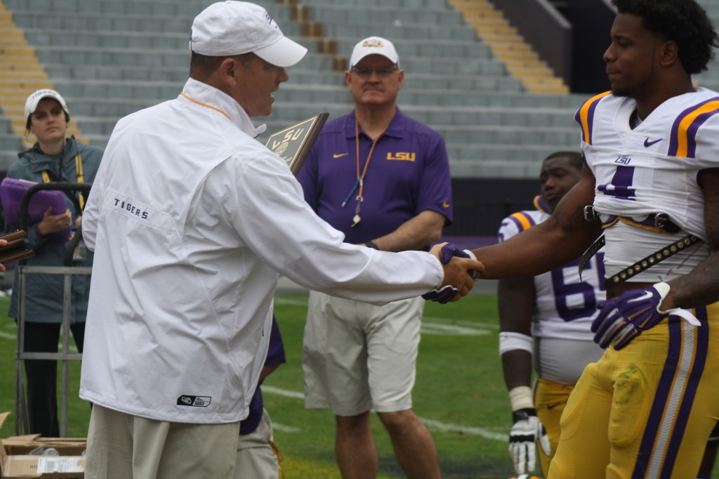 Coach Miles gives a award to Kwon Alexander