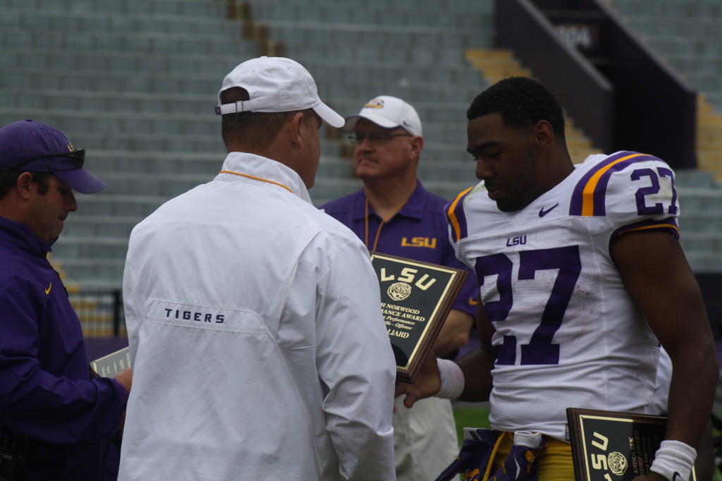 Coach Miles gives a award to Kenny Hillard