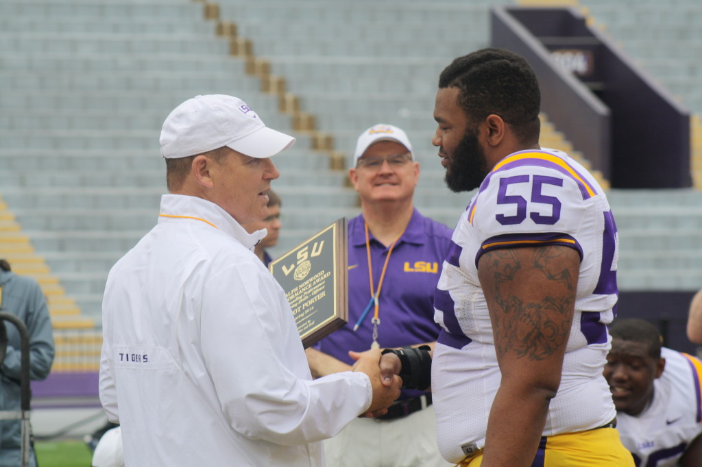 Coach Miles gives a award to Ellioit Porter