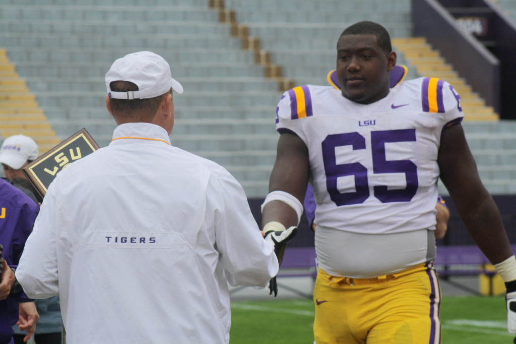 Coach Miles ready to give a award to Jerald Hawkins