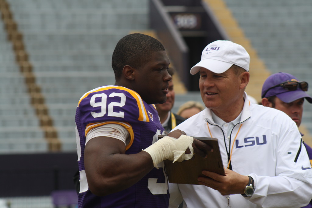 Lewis Neal receives his award from Coach Miles