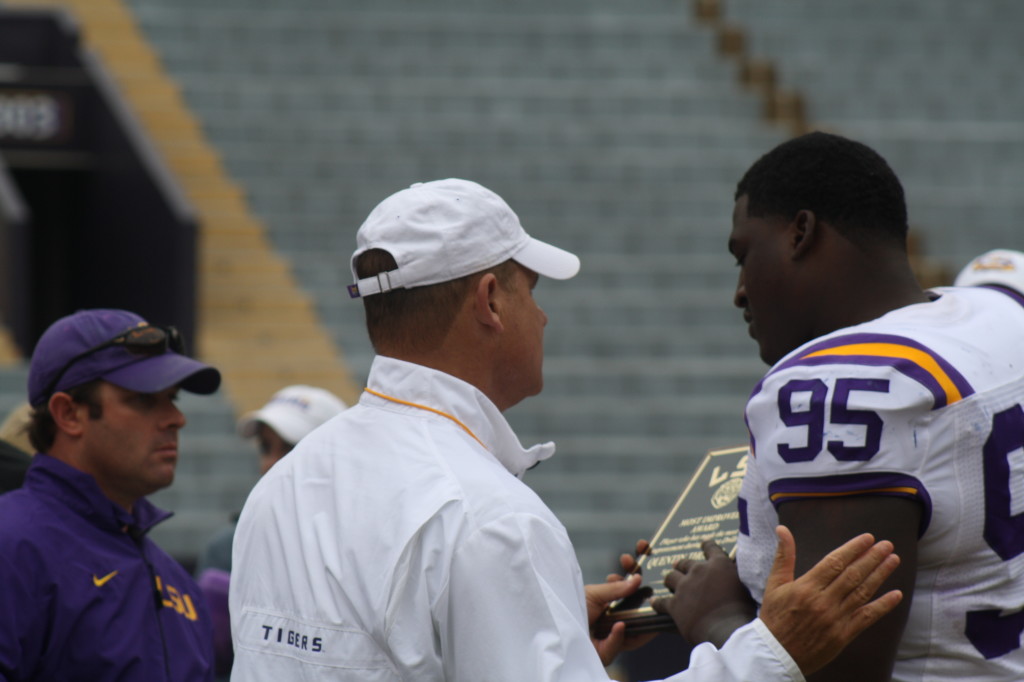 Quentin Thomas receives a award from Coach Miles