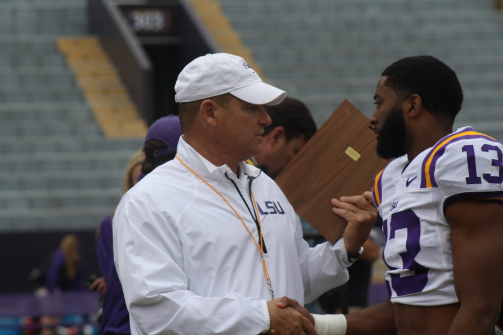 Dwayne Thomas gets a award from Coach Miles