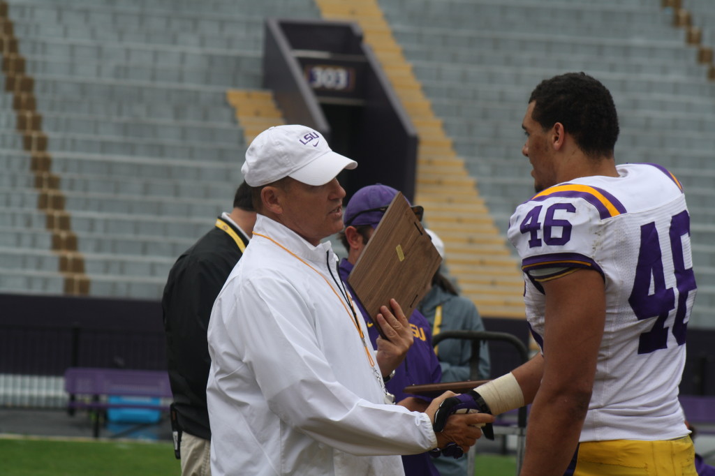Tashawn Bower receives a award from Coach Miles