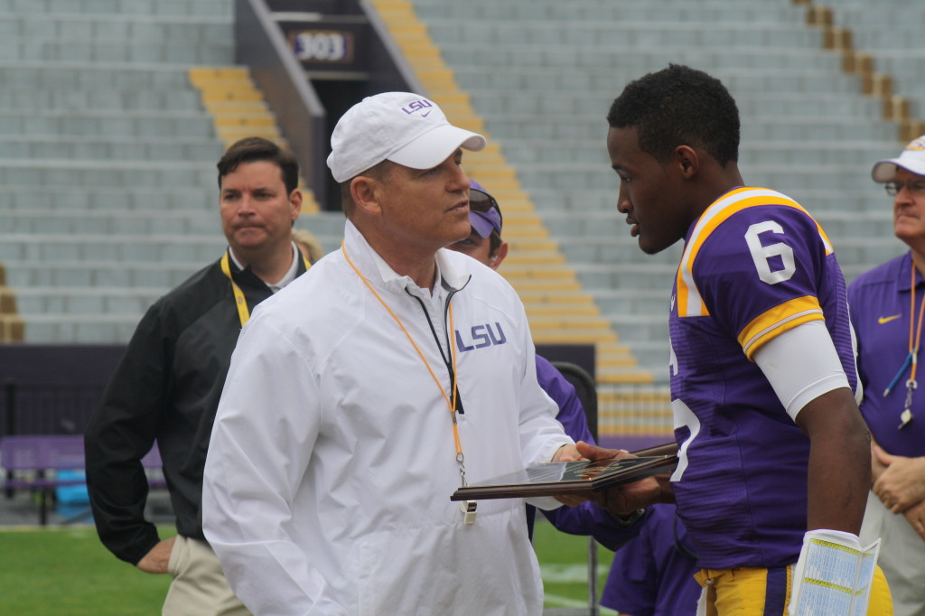 Coach Miles gives Brandon Harris a award.