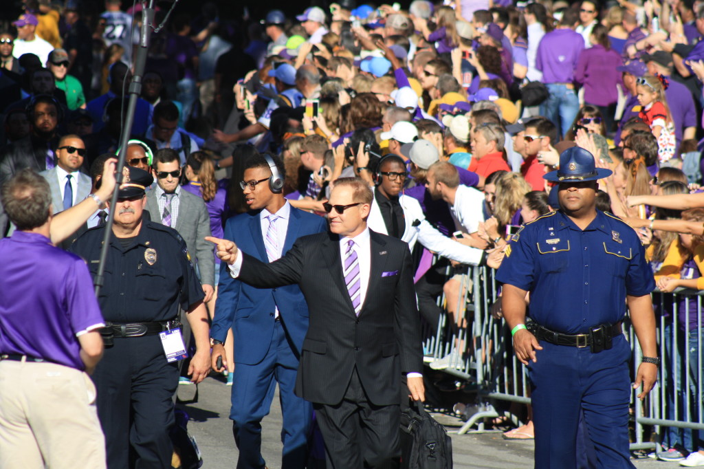 Coach Miles walking down to Tiger Stadium with the team.