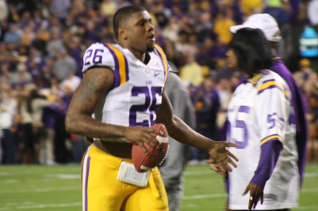 no.26 Ronald Martin running to meet his family during Senior Day as a LSU Tiger.
