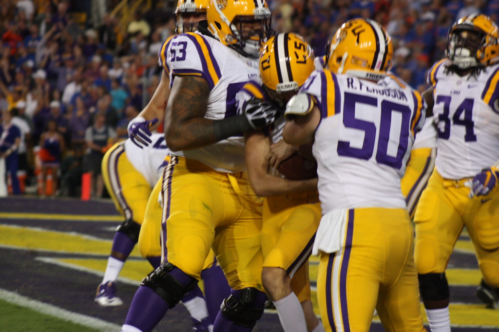 LSU K Trent Domingue gets mobbed by his teammates and still holding on to the ball.