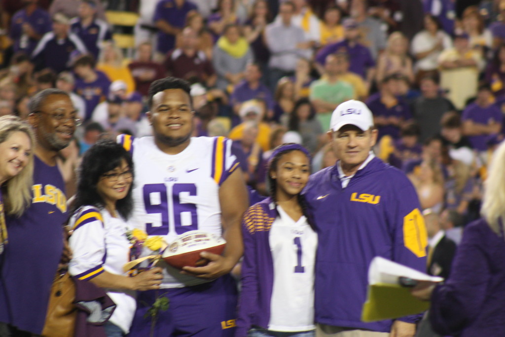 Coach Miles taking a pic with Micky Johnson and his family.
